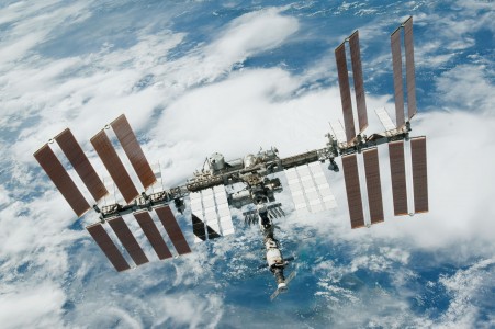 Backdropped by a blue and white part of Earth, the International Space Station is featured in this image photographed by an STS-130 crew member on space shuttle Endeavour after the station and shuttle began their post-undocking relative separation. Undocking of the two spacecraft occurred at 7:54 p.m. (EST) on Feb. 19, 2010.