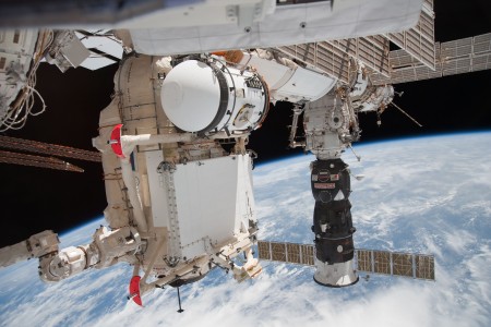 In the grasp of the station's robotic Canadarm2, the Russian-built Mini-Research Module 1 (MRM-1) is attached to the Earth-facing port of the Zarya Functional Cargo Block (FGB) of the International Space Station. Named Rassvet, Russian for 