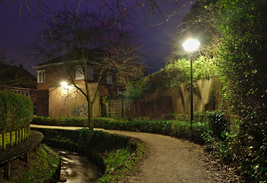 La vallée de la Woluwe walking path between Rue Charles Lemaire and (towards) Clos des Pommiers Fleuris (Auderghem, Belgium) on a December evening (nautical twilight)