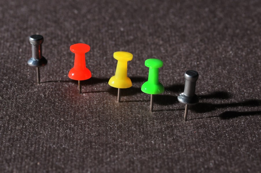 A line of colored pushpins