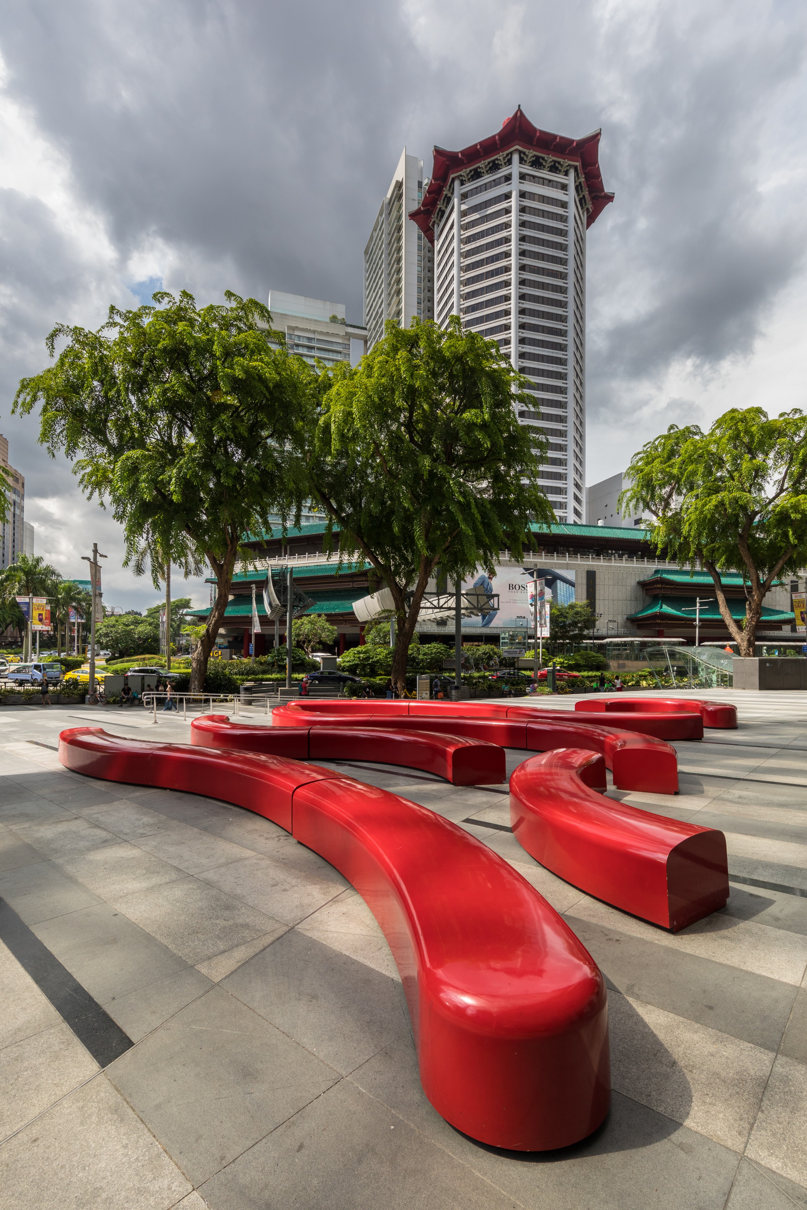 Red curved benches with Angsana trees near the Singapore Marriott Tang Plaza tower