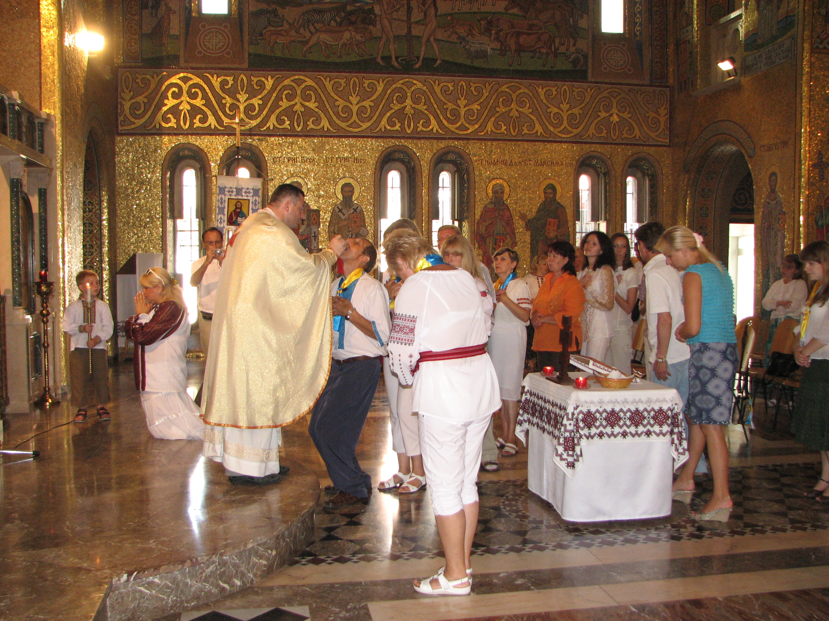 People are taking the Holy Communion in a Greek-Catholic Church in Rome, Italy, European Union, August 2011, picture 17.