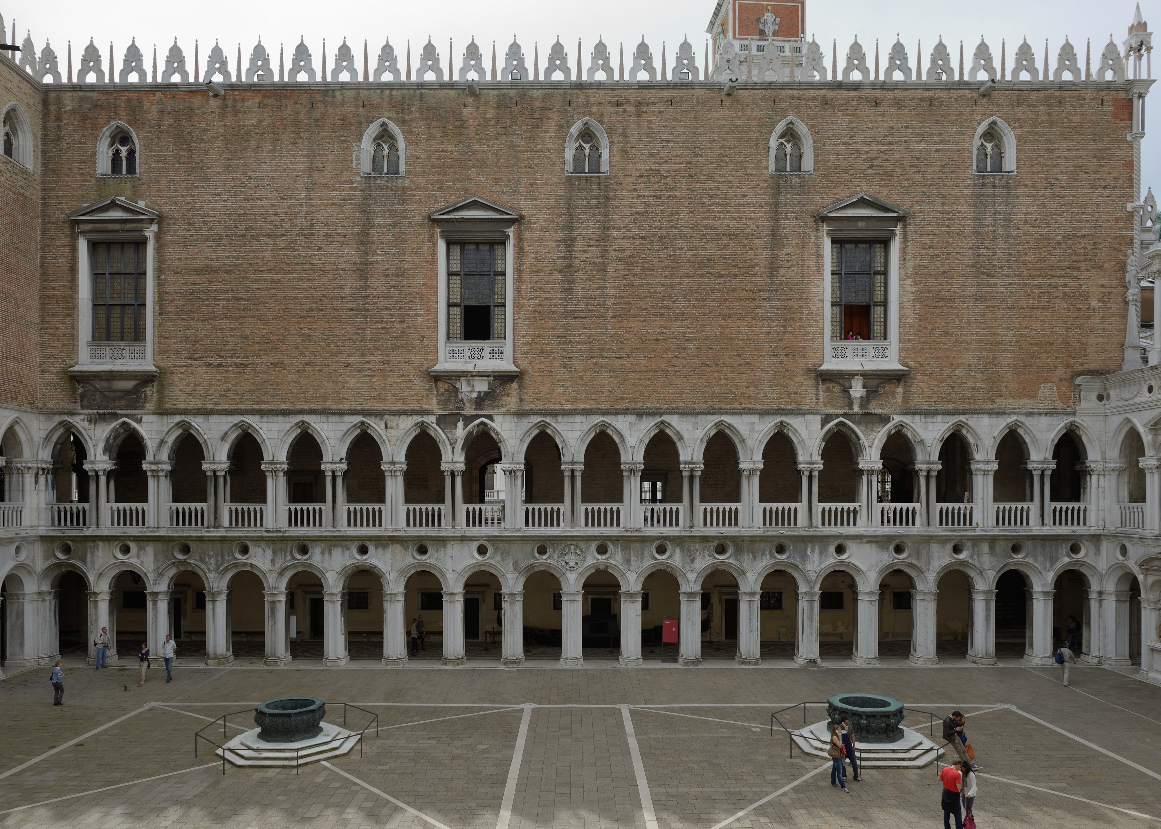 Bronze wells and Western face courtyard of Doges palace Venice