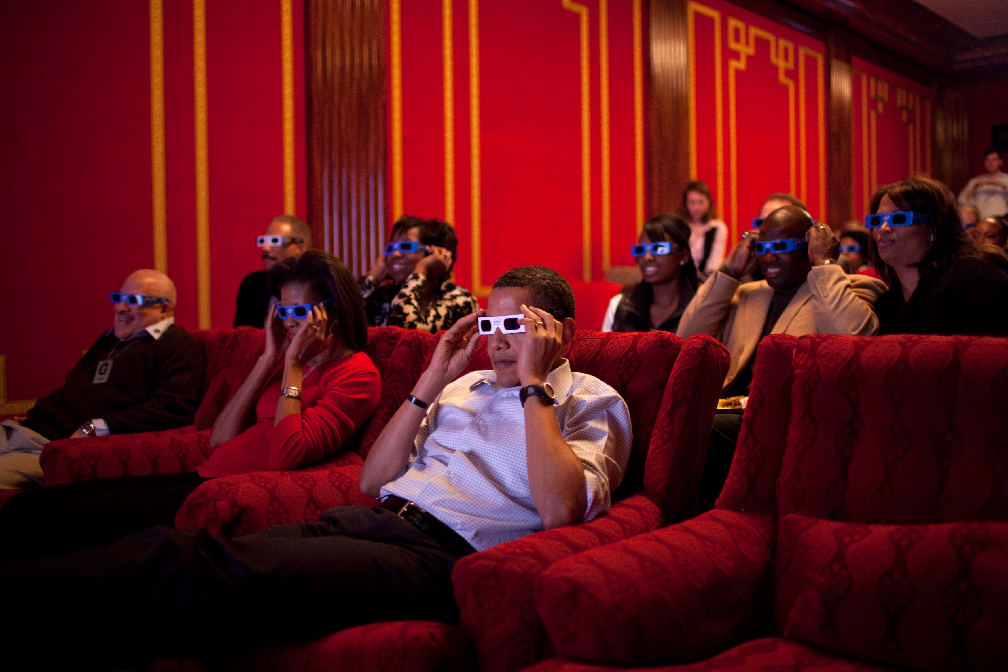 Barack and Michelle Obama looking the 2009 Superbowl with 3-D glasses