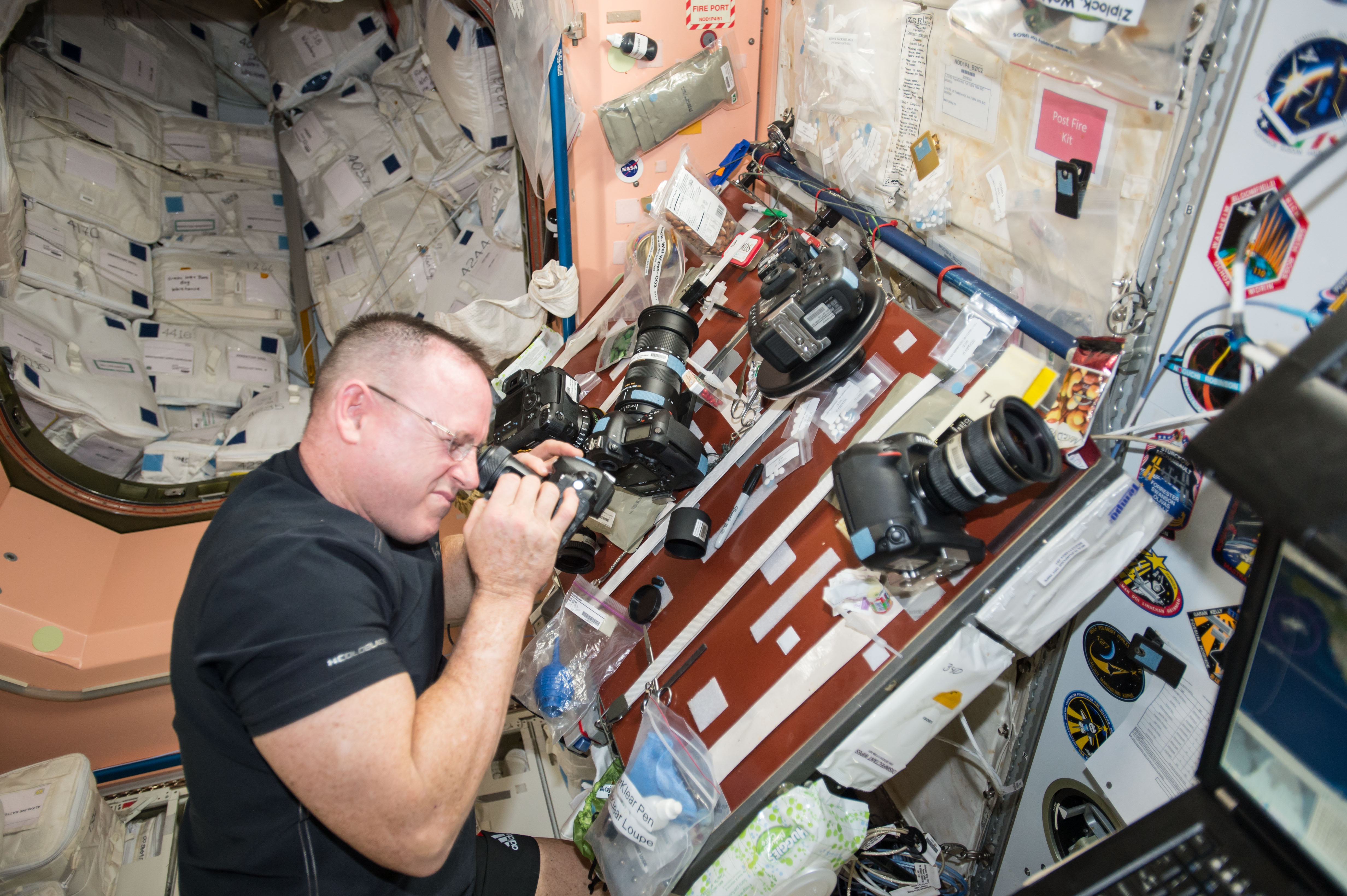 ISS-42 Barry Wilmore inspects the cameras in the Unity module
