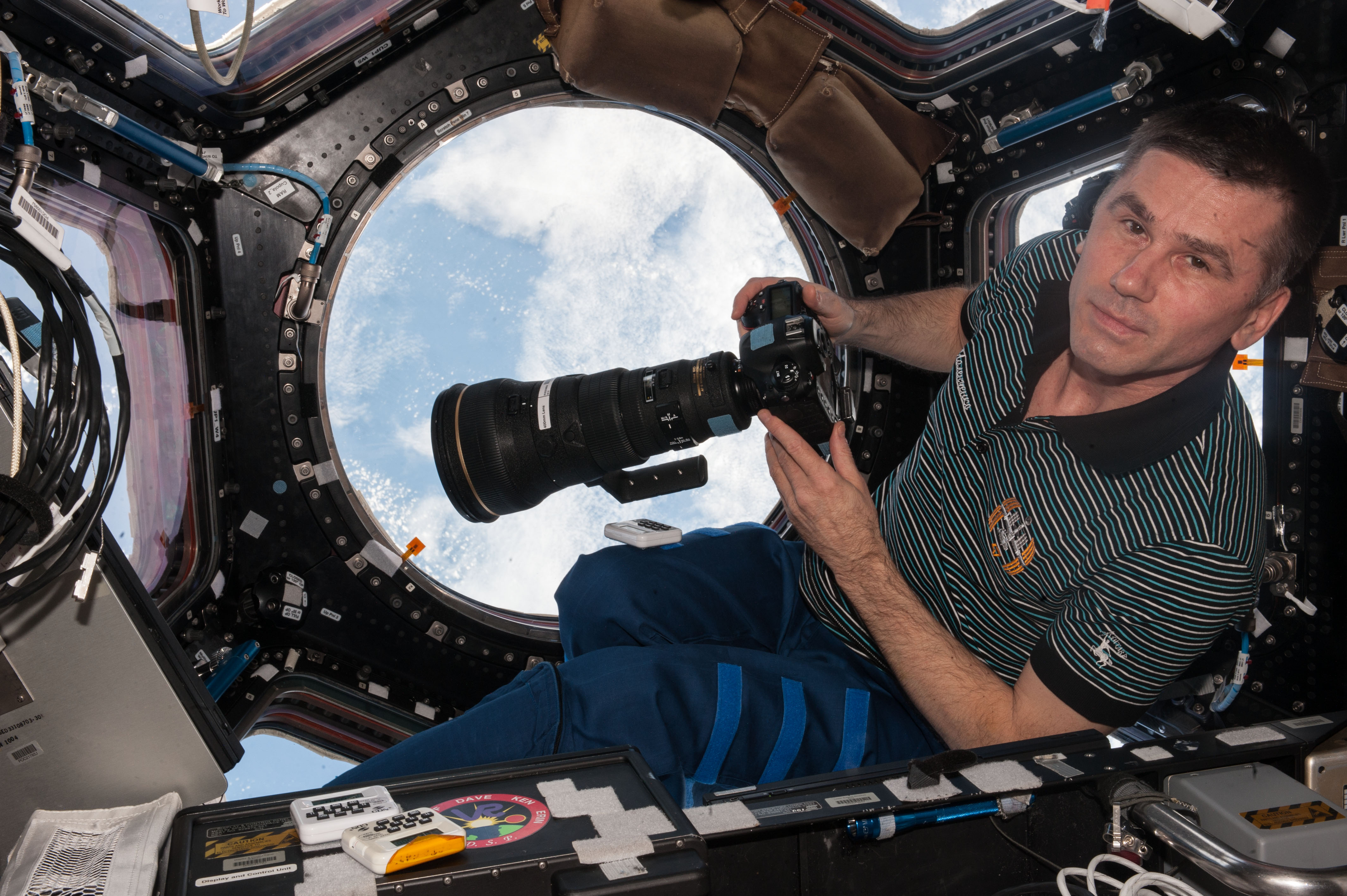 ISS-47 Yuri Malenchenko with camera in the Cupola module