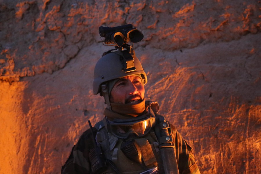 An Afghan National Army commando with the 3rd Company, 3rd Special Operations Kandak stands by a fire to stay warm in Bahlozi, Maiwand district, Kandahar province, Afghanistan, Jan. 1, 2014 140101-A-LW390-118