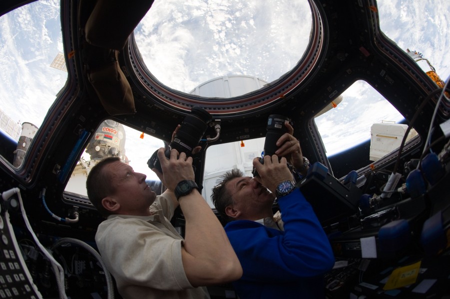 ISS-27 Dmitri Kondratyev and Paolo Nespoli photograph the Earth through the Cupola