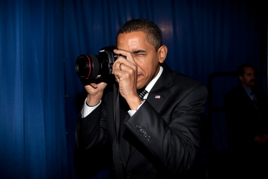 President Barack Obama holding a canon camera