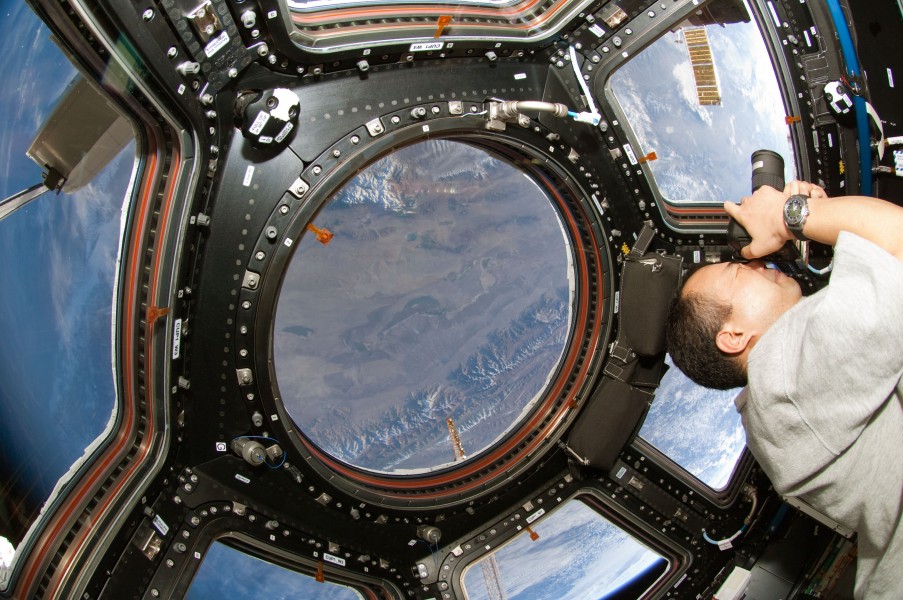 STS-130 Soichi Noguchi photographs through Cupola