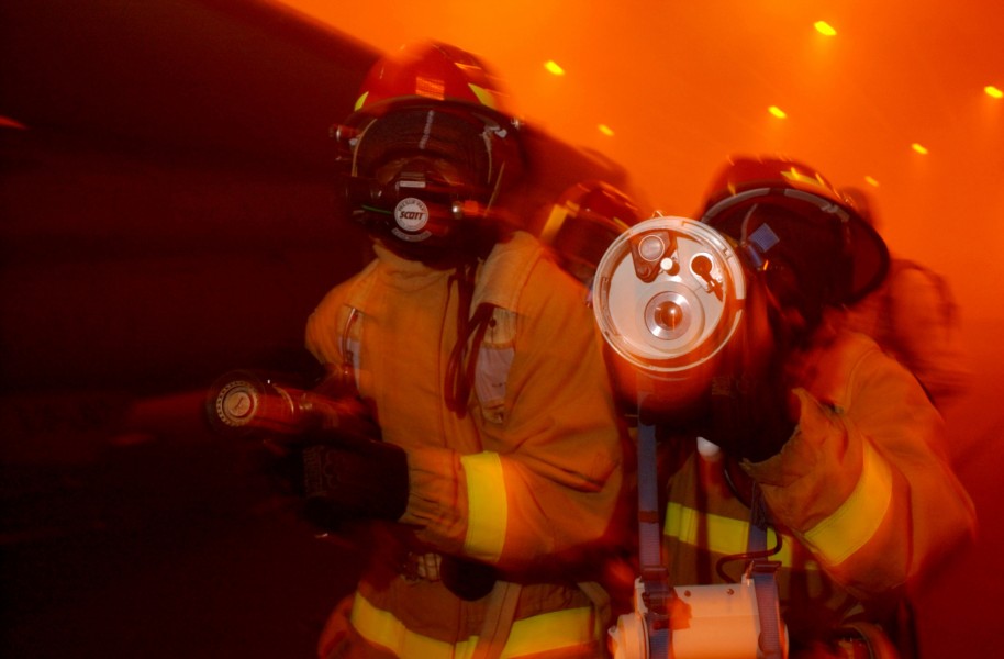 US Navy 040419-N-9851B-076 A fire team uses a Naval Firefighter Thermal Imager (NFTI) while advancing on a simulated fire
