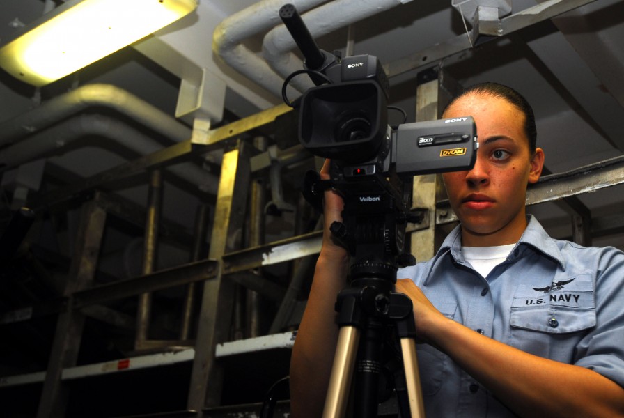 US Navy 070309-N-9928E-031 Mass Communication Specialist Seaman Leah Allen films a weapons exercise in weapons department's ordnance assembly division workshop