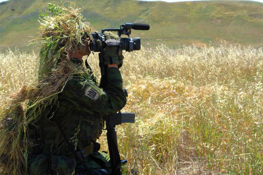 US Navy 070424-N-9643K-007 A combat videographer practices evasion techniques while on a mock patrol during Quick Shot 2007