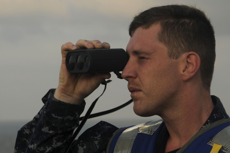 US Navy 100206-N-3038W-136 uarter Master Seaman Apprentice Dustin Smith uses a laser range finder to check the distance and range in preparation for a replenishment at sea aboard the aircraft carrier USS Nimitz(CVN 68)