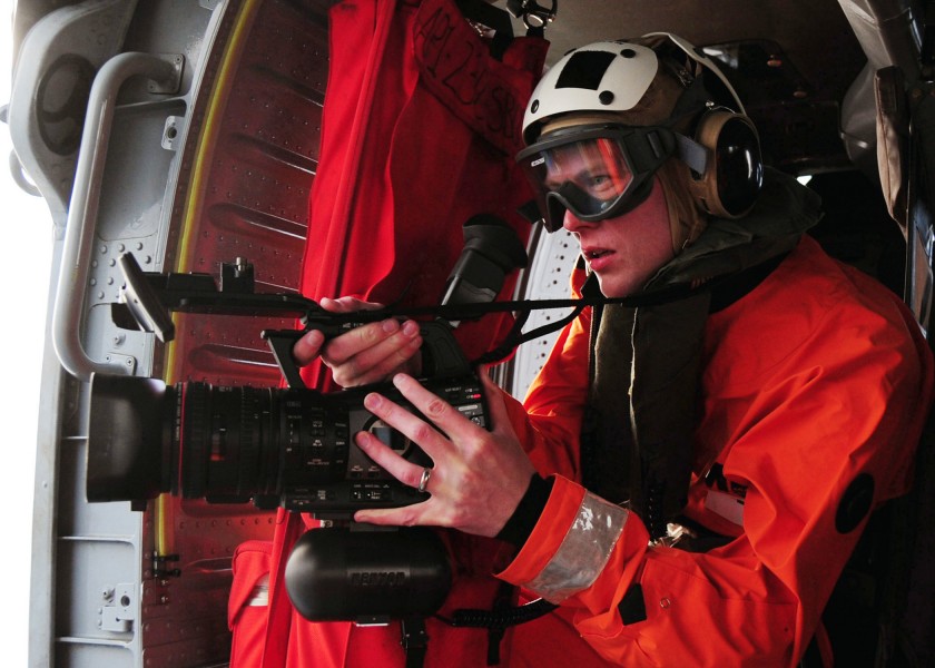 US Navy 110520-N-VQ827-688 Mass Communication Specialist 3rd Class Timothy Walter records video from a helicopter during the Royal Navy-sponsored j