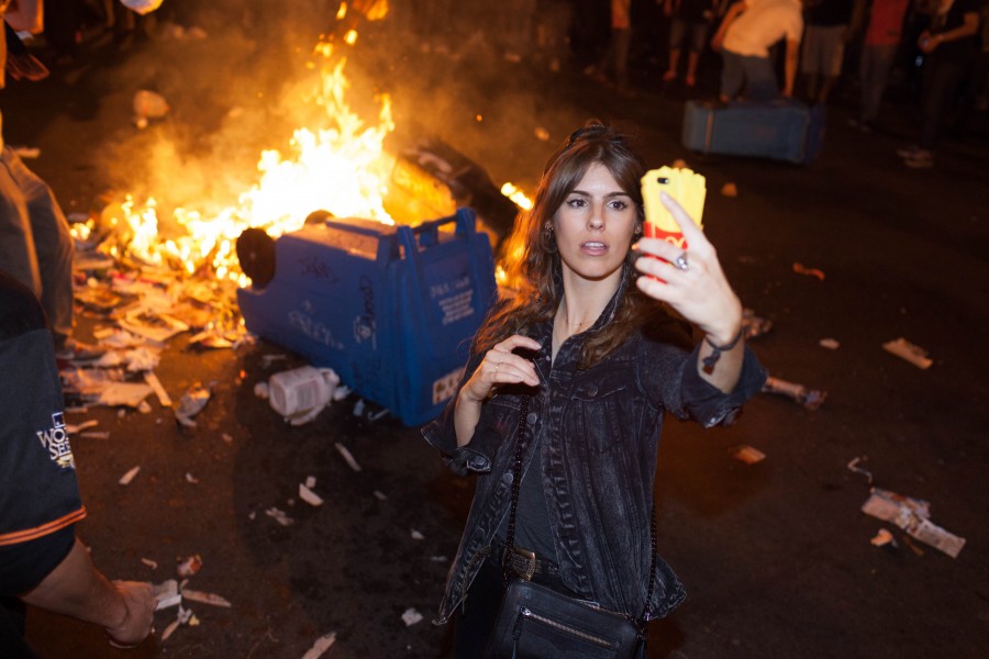 Woman taking bonfire selfie - San Francisco Giants World Series 2014 celebration