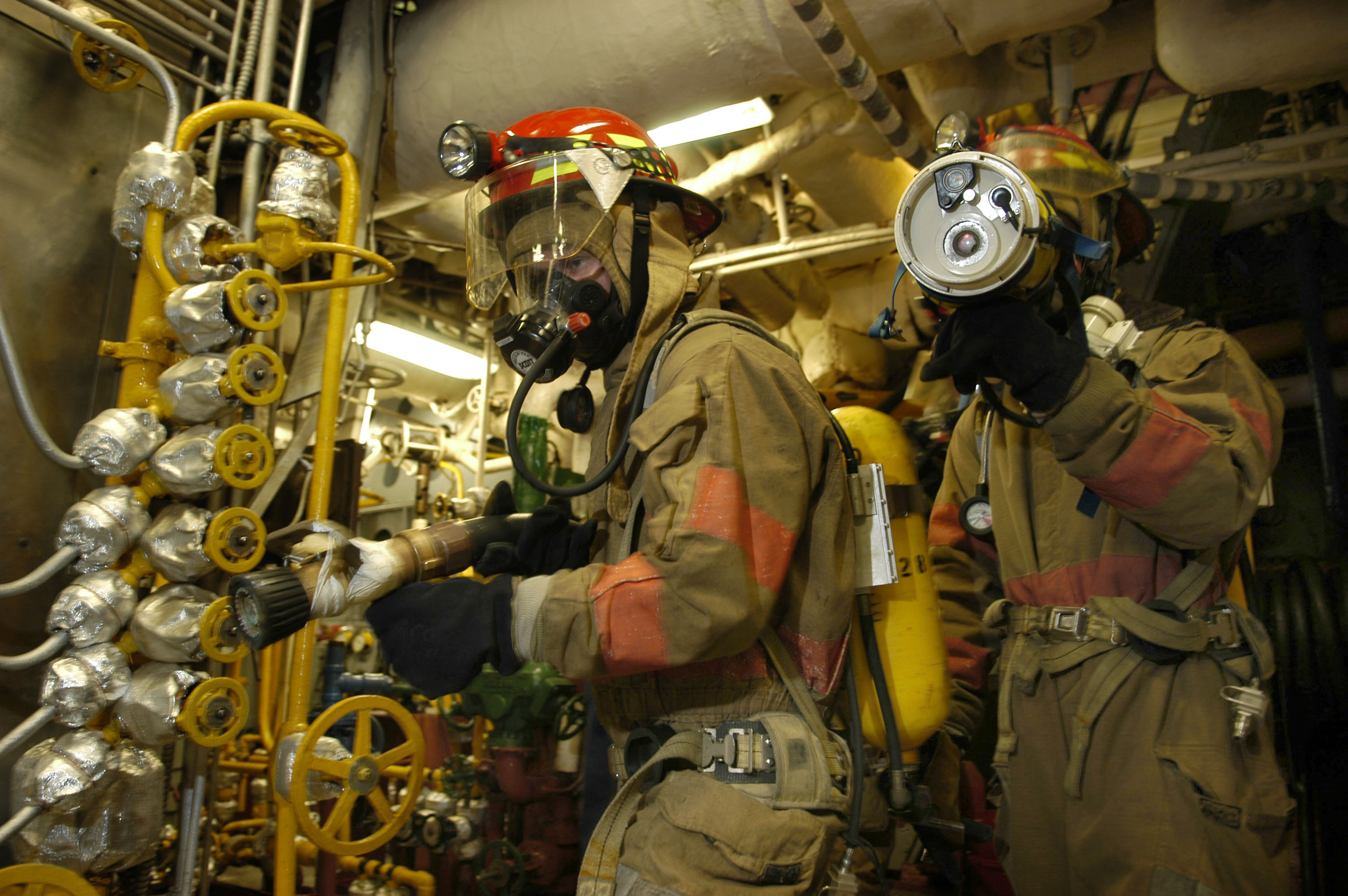 US Navy 050826-N-3136P-108 An on-scene leader uses a Naval Firefighter Thermal Imaging Device (NFTI) to search for fires during a main space fire drill aboard the conventionally-powered aircraft carrier USS Kitty Hawk (CV 63)