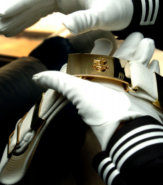 US Navy 040220-N-6213R-008 Airman Pedro Feliciano, of Philadelphia, Pa., shines his belt buckle while traveling to a performance as a member of the U.S. Navy Ceremonial Guard