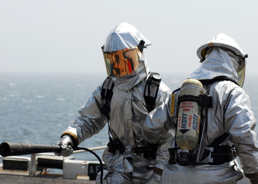 US Navy 080905-N-2183K-067 Crash and salvage crew members wearing proximity suits participate a flight deck fire drill aboard the amphibious assault ship USS Peleliu (LHA 5)