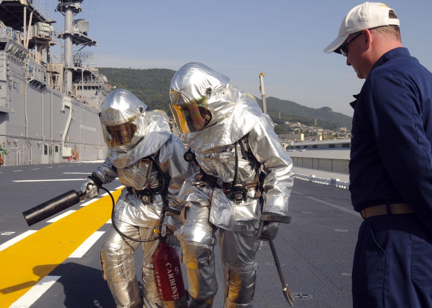 US Navy 091021-N-9950J-202 Aviation Boatswain's Mate (Handling) 3rd Class Araminta McIntosh, left, and Aviation Boatswain's Mate (Handling) Airman Chad Dornbusch participate in a fire drill
