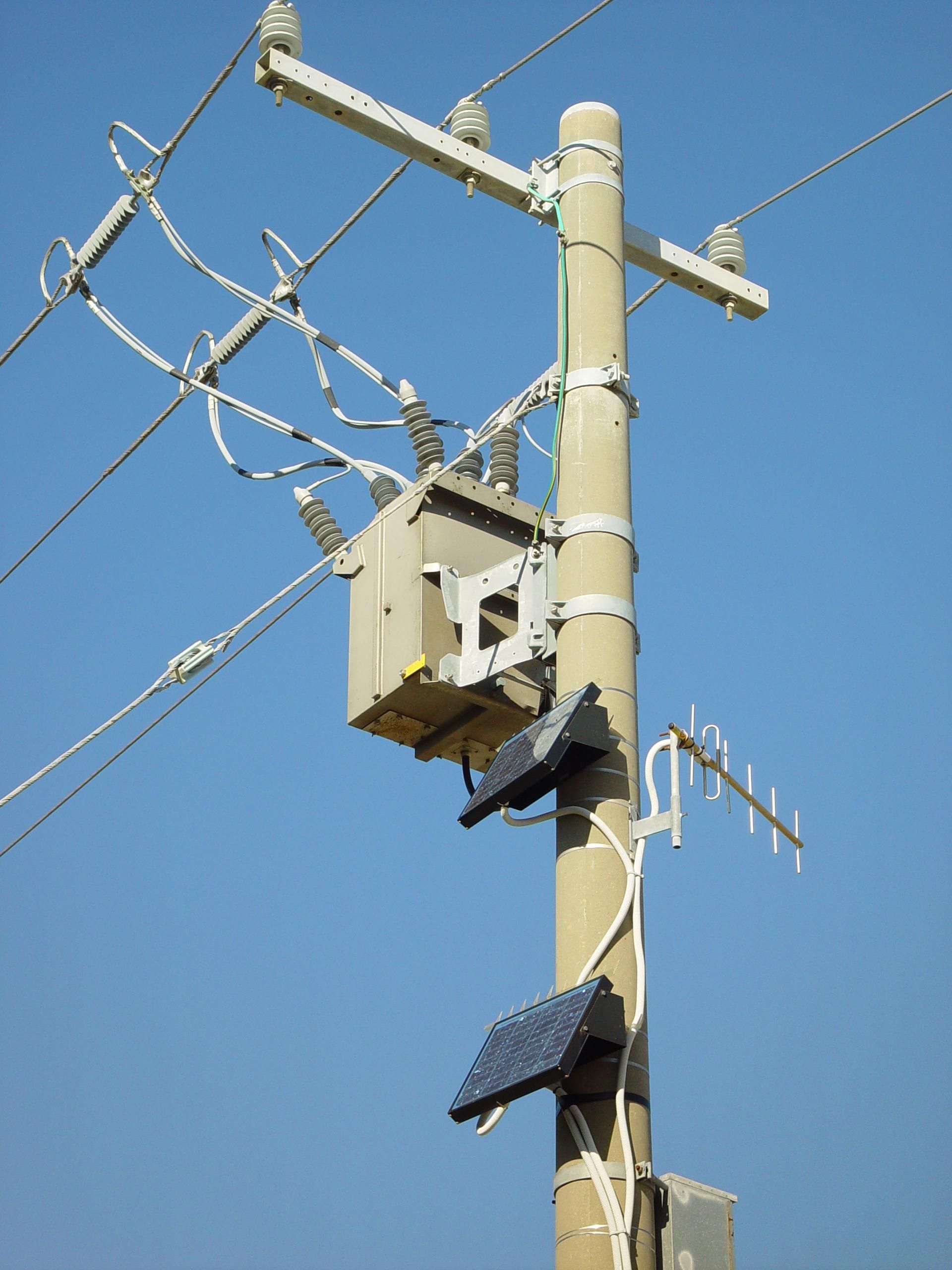 Busy power pole with solar panels