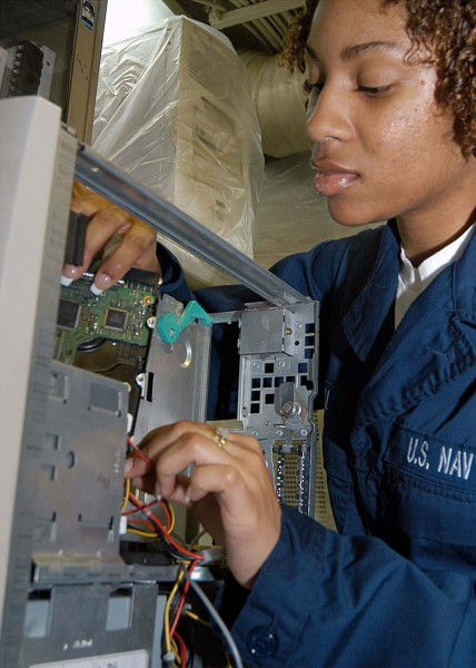 US Navy 040325-N-1512S-019 Information Systems Technician 2nd Class Quemeka Hill conducts maintenance on a Central Processing Unit (CPU) in Computer Repair aboard the amphibious assault ship USS Kearsarge (LHD 3)
