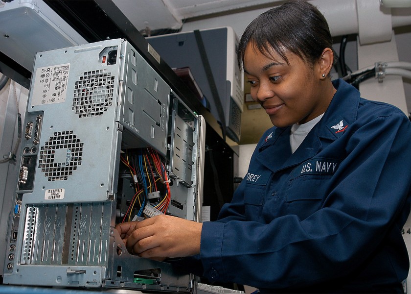 US Navy 040418-N-1522S-007 Information Systems Technician 3rd Class Lakita Corey, of Williamston, N.C., fixes a computer