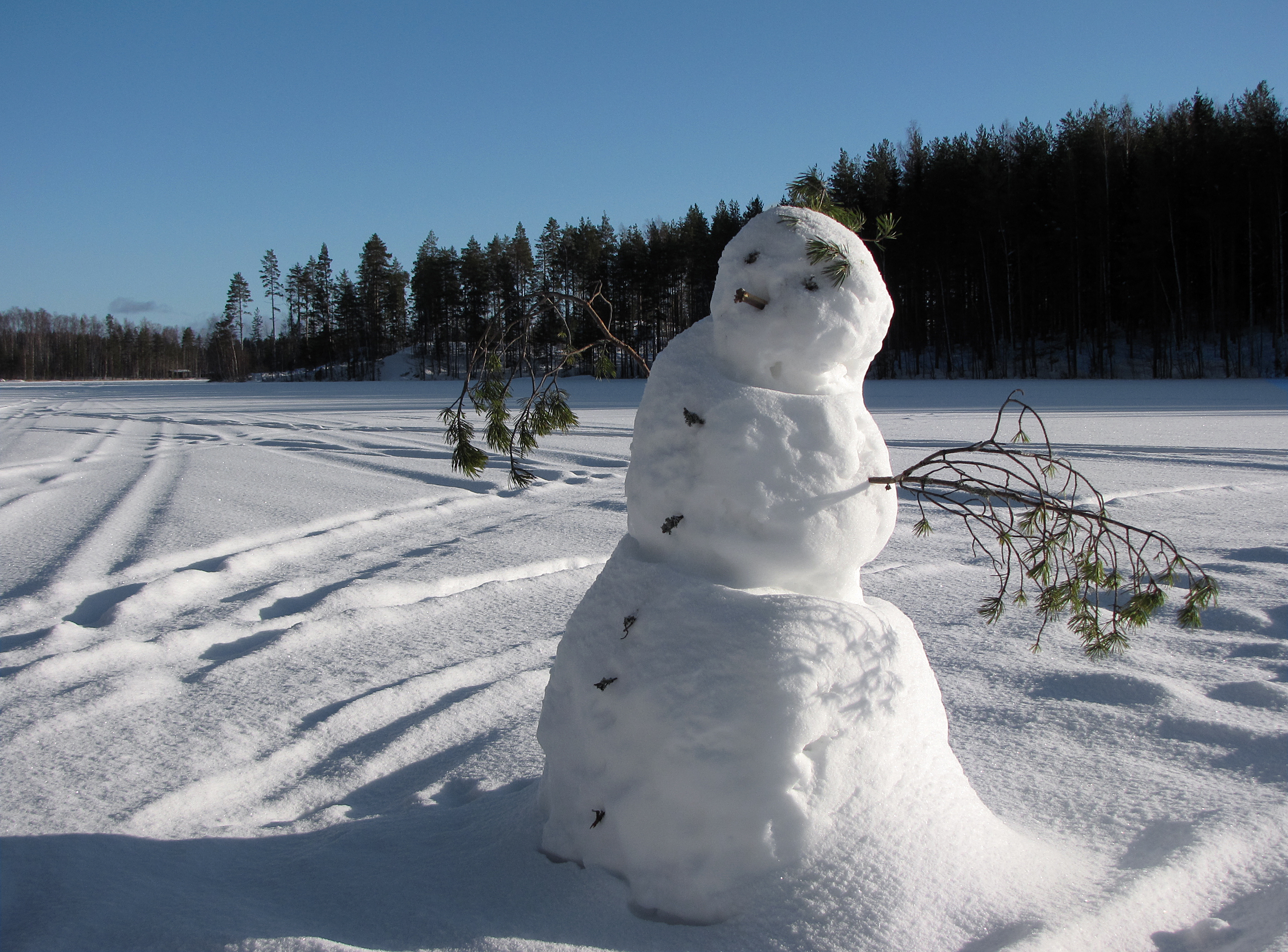 Snowman on frozen lake