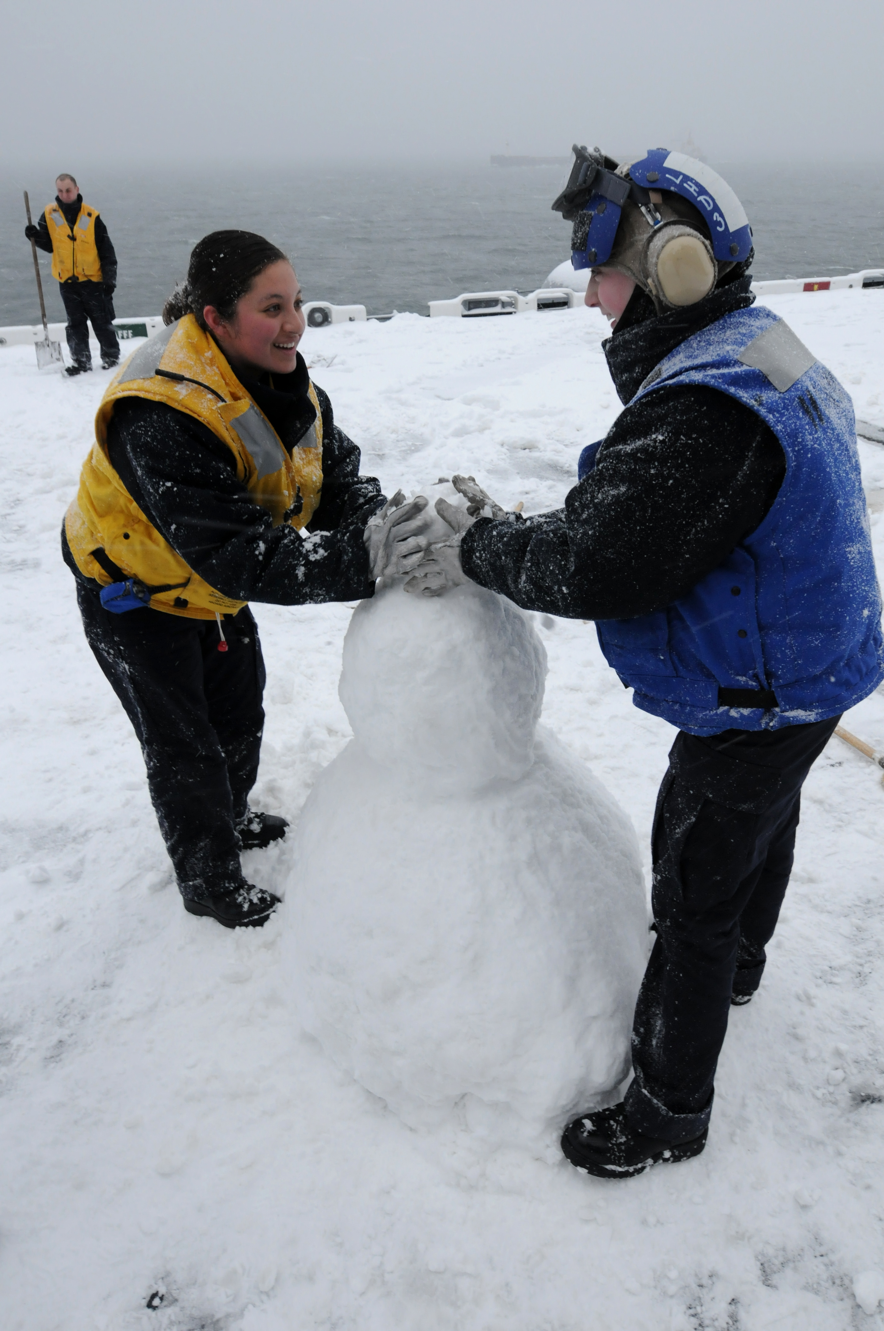 US Navy 100129-N-0080L-209 Sailors build a snowman aboard USS Kearsarge