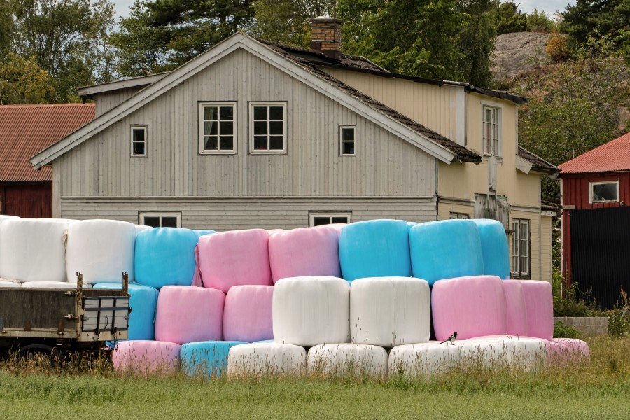 Pink blue and white silage bales