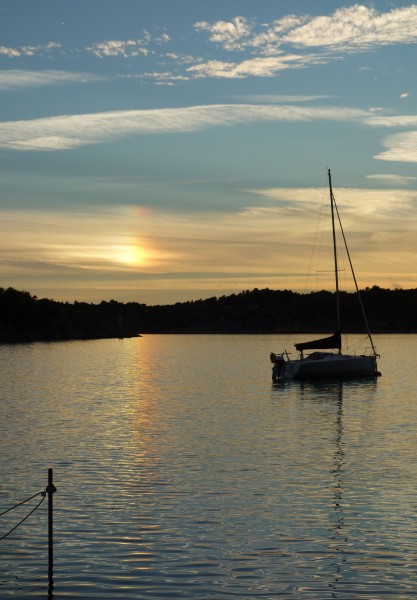 Sun dog with reflection and sailboat at Brofjorden