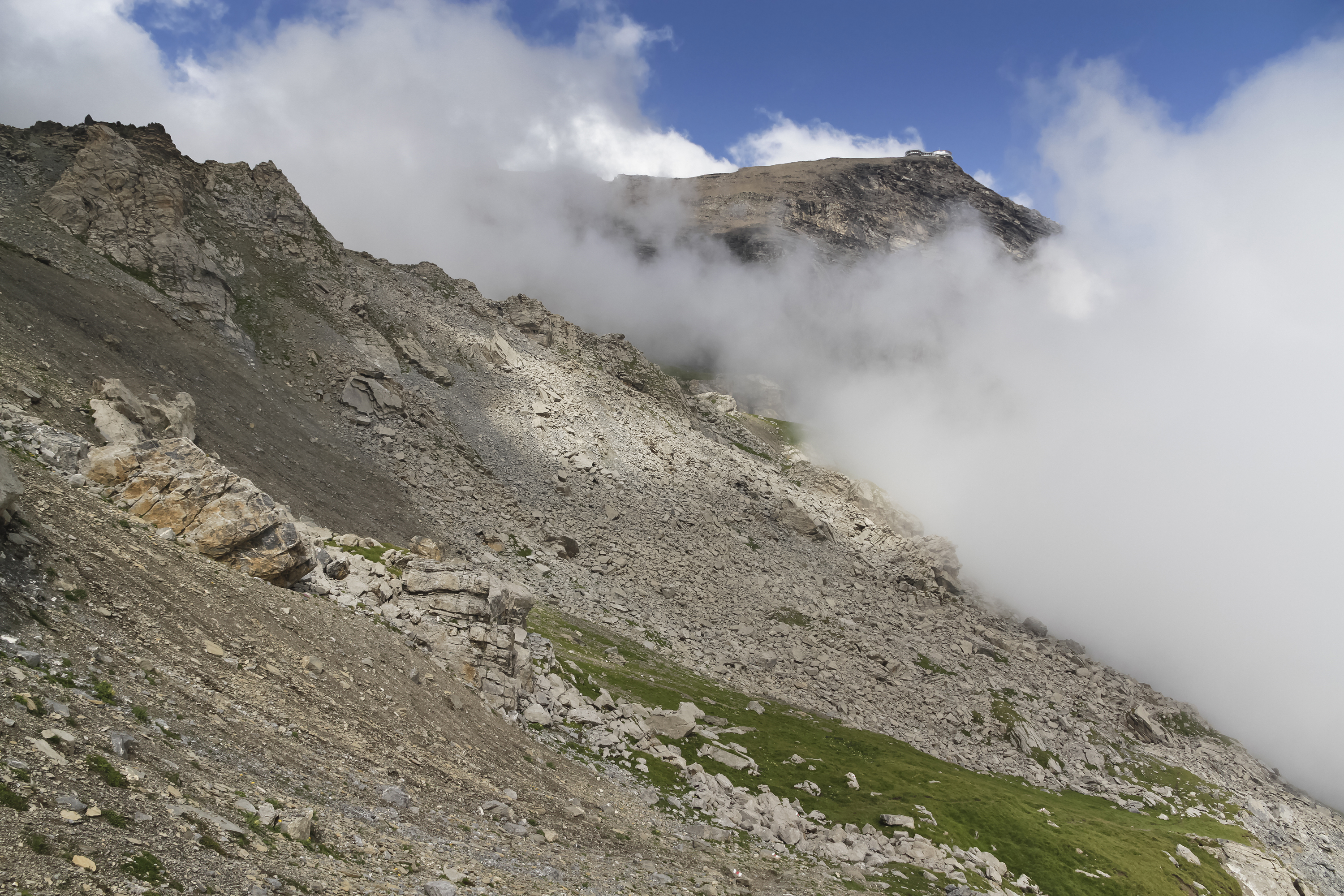 Summit of Schilthorn reveals itself above the clouds in 2012 August