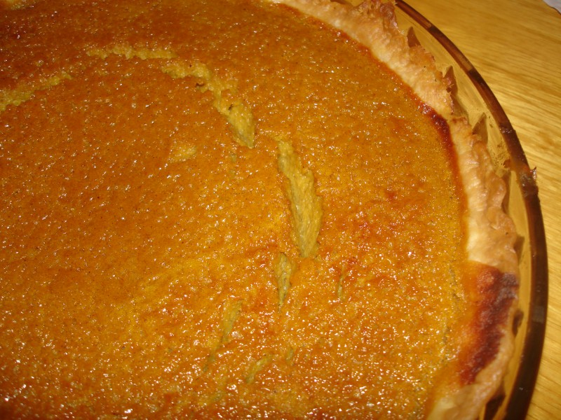 Homemade Pumpkin pie with cracked surface in glass bakeware, November 2009