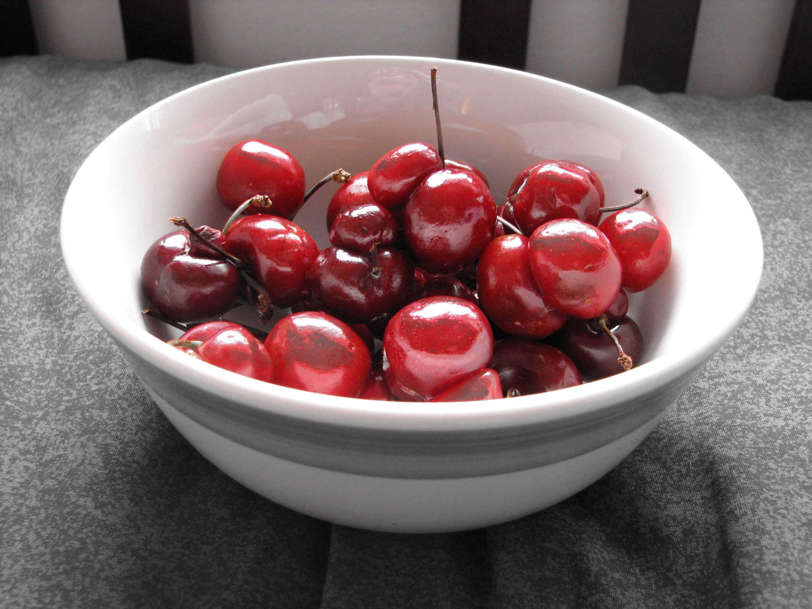 Bowl of cherries with red accent