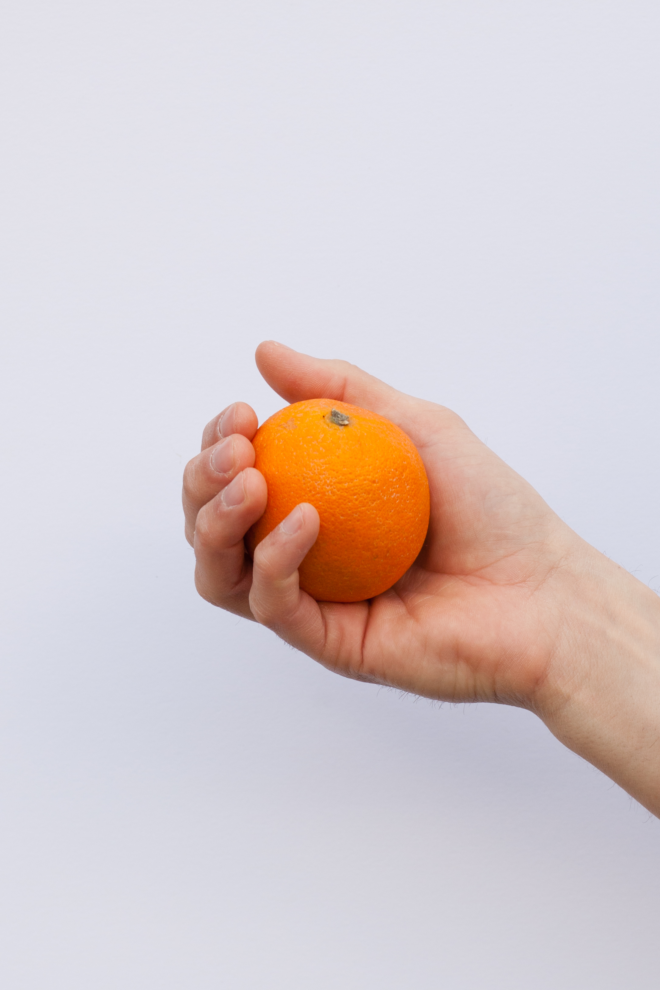 Orange held in hand