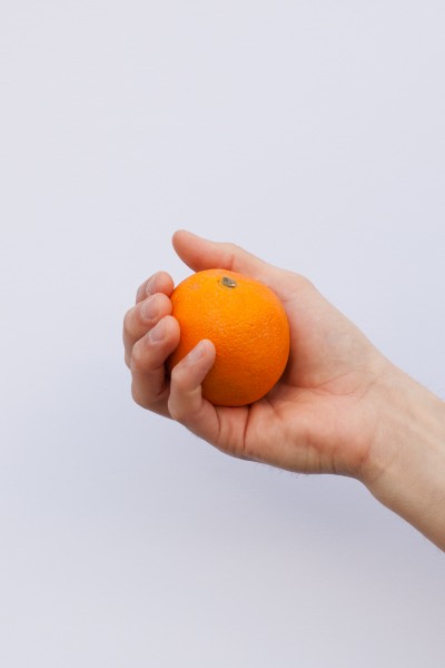 Orange held in hand
