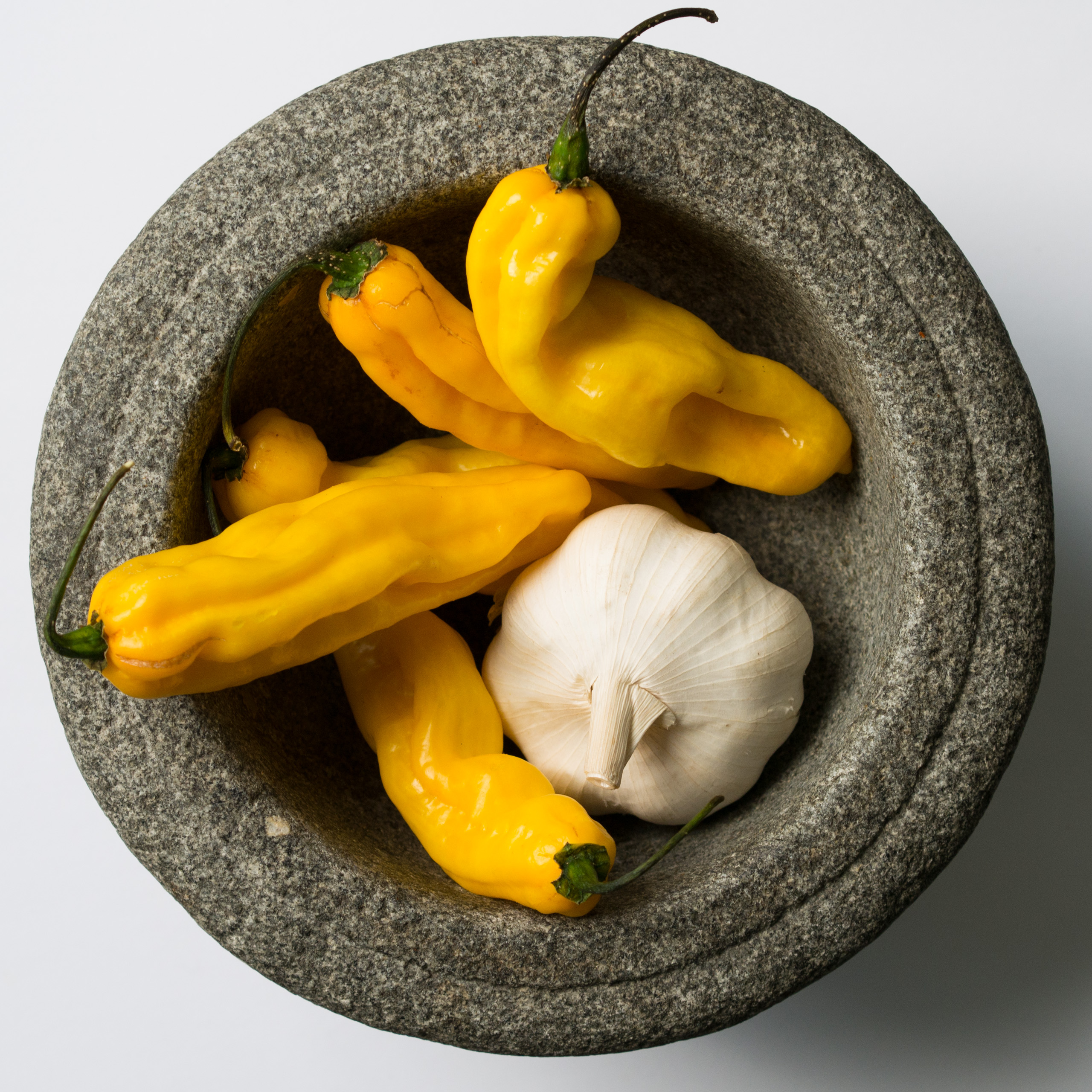 Madamme Jeannette peppers in stone mortar