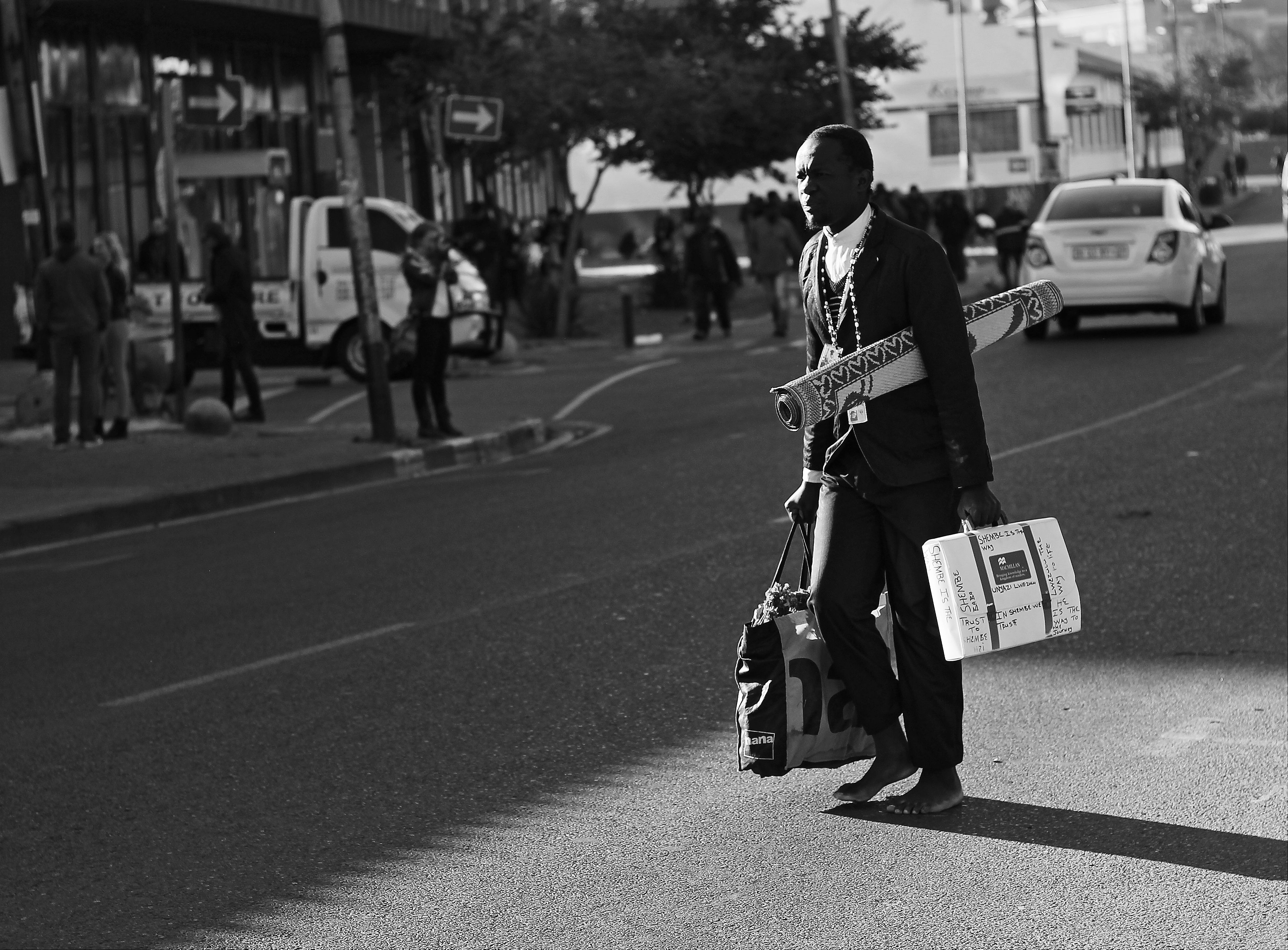 A traditional dance performer, barefooted and on his way to work (Doornfontein, 2015)