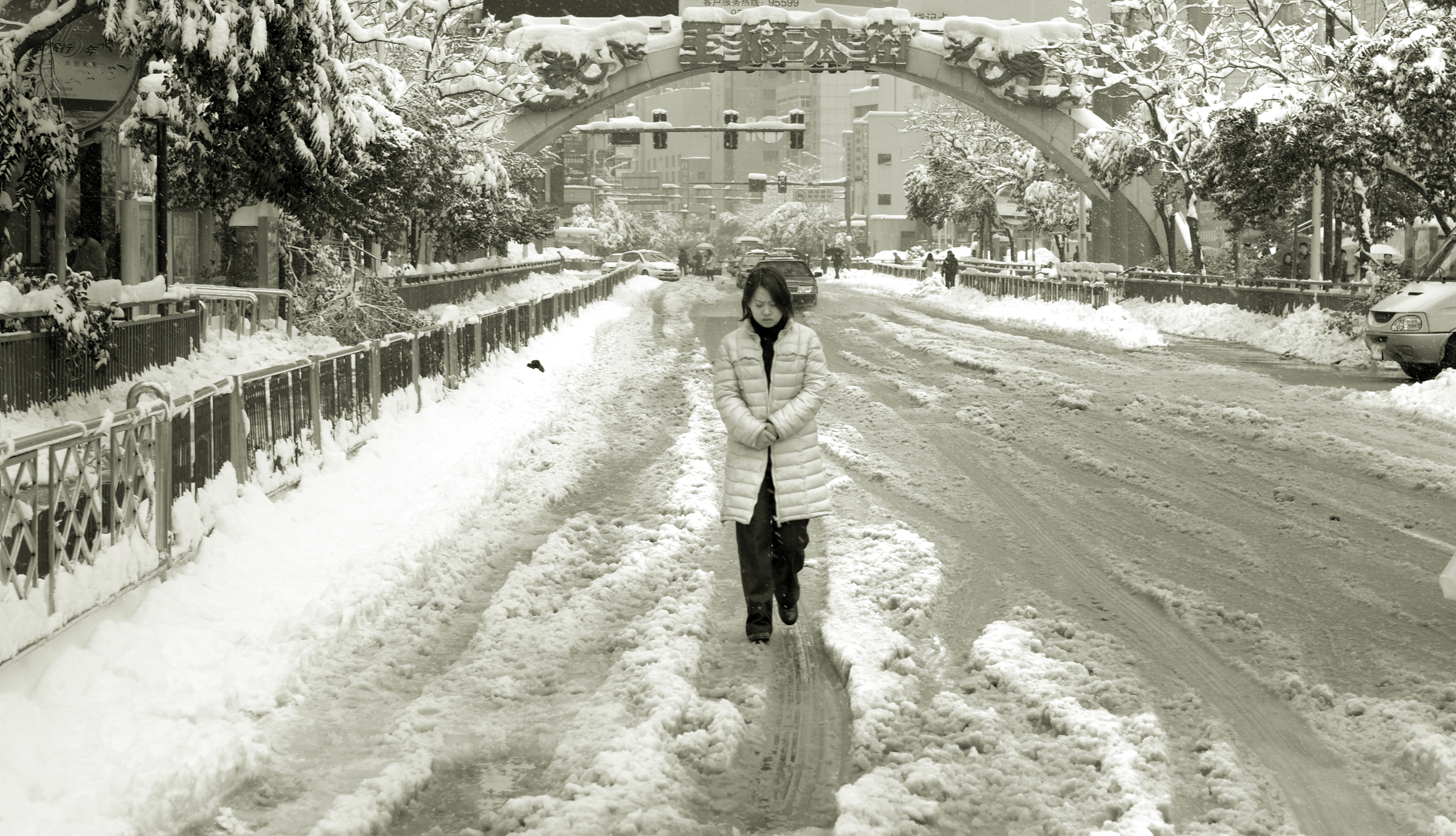 A woman is walking in the snow