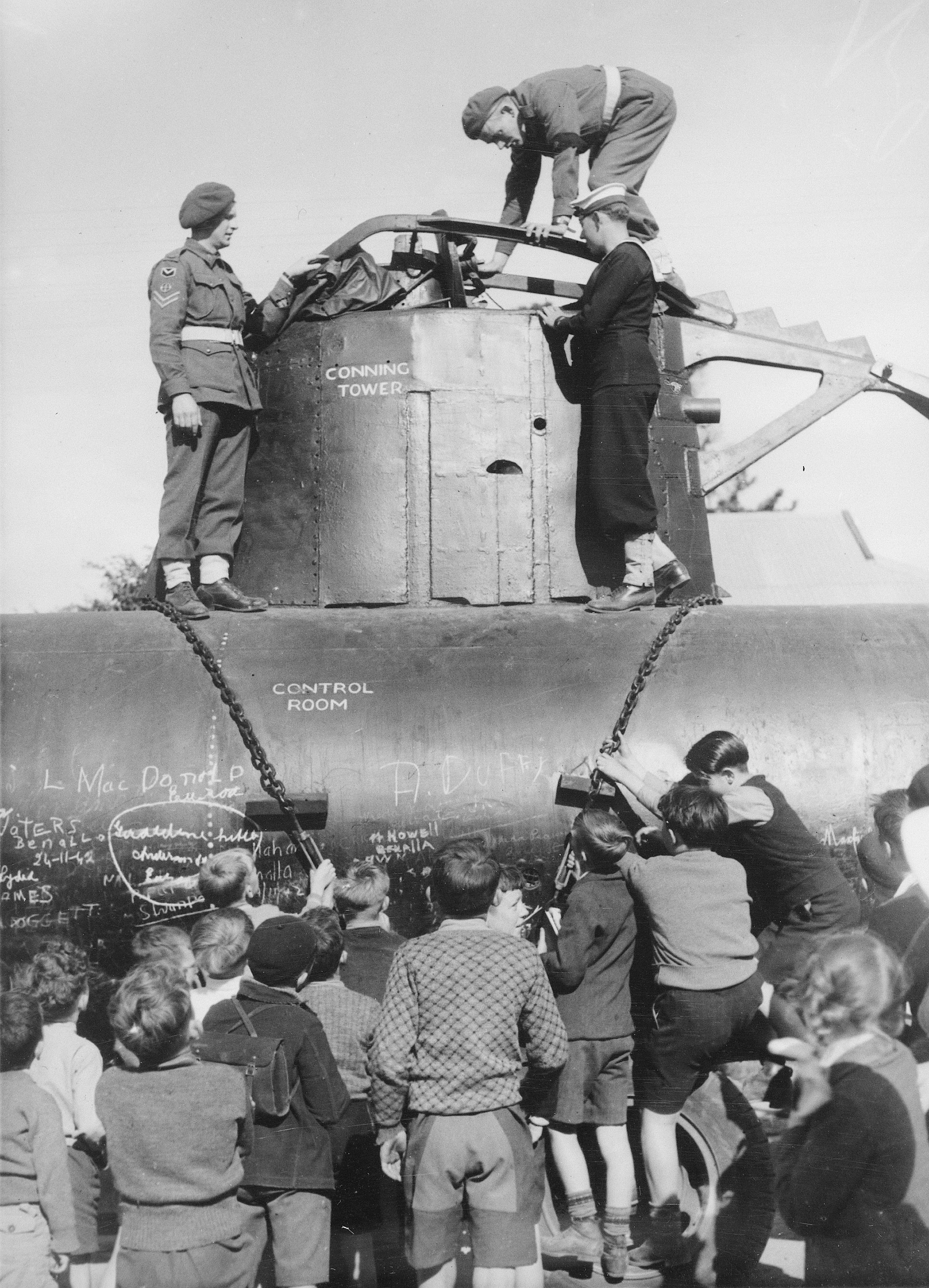 Children inspecting a Japanese midget submarine, 1942 (3702945655)