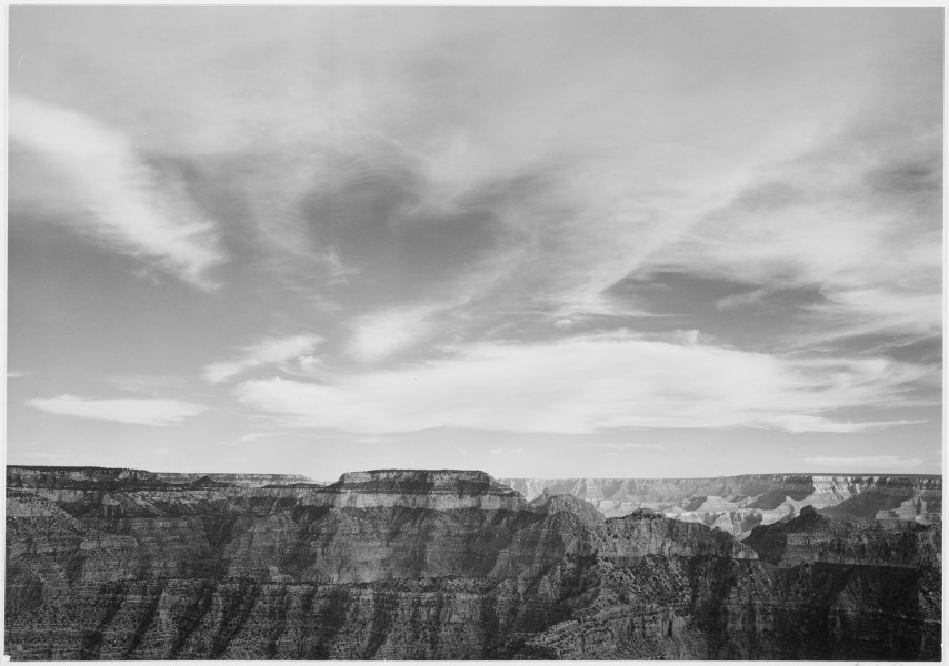 Canyon edge, low horizon, clouded sky, 