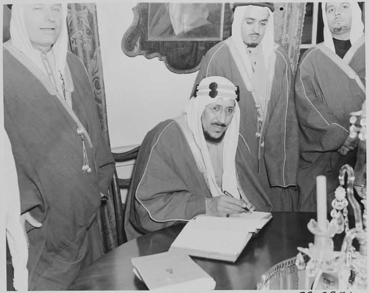 Photograph of Crown Prince Amir Saud of Saudi Arabia signing the guest book at Mount Vernon, as other Saudi Arabian... - NARA - 199526