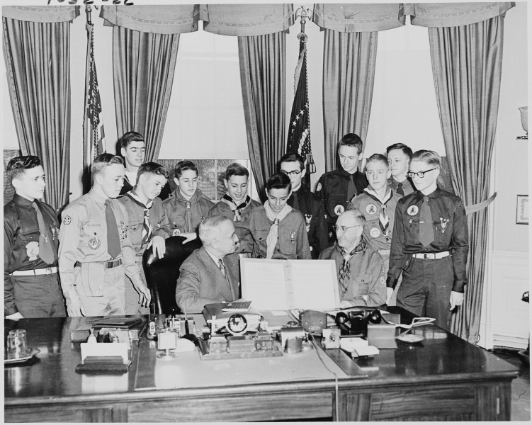 Photograph of President Truman in the Oval Office, receiving a report on the accomplishments of the Boy Scouts from a... - NARA - 200268