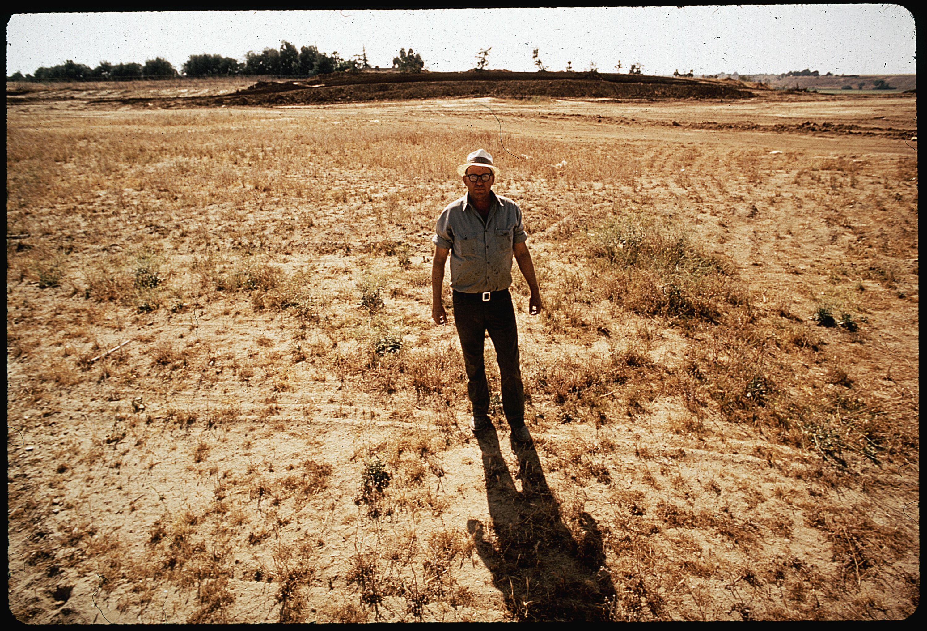 CLYDE KEPLEY, OWNER OF SANITARY LAND FILL, STANDS ON HIS 13 ACRE FINISHED AREA, WHICH HAS FILL DEPTHS TO 80 FEET - NARA - 542548