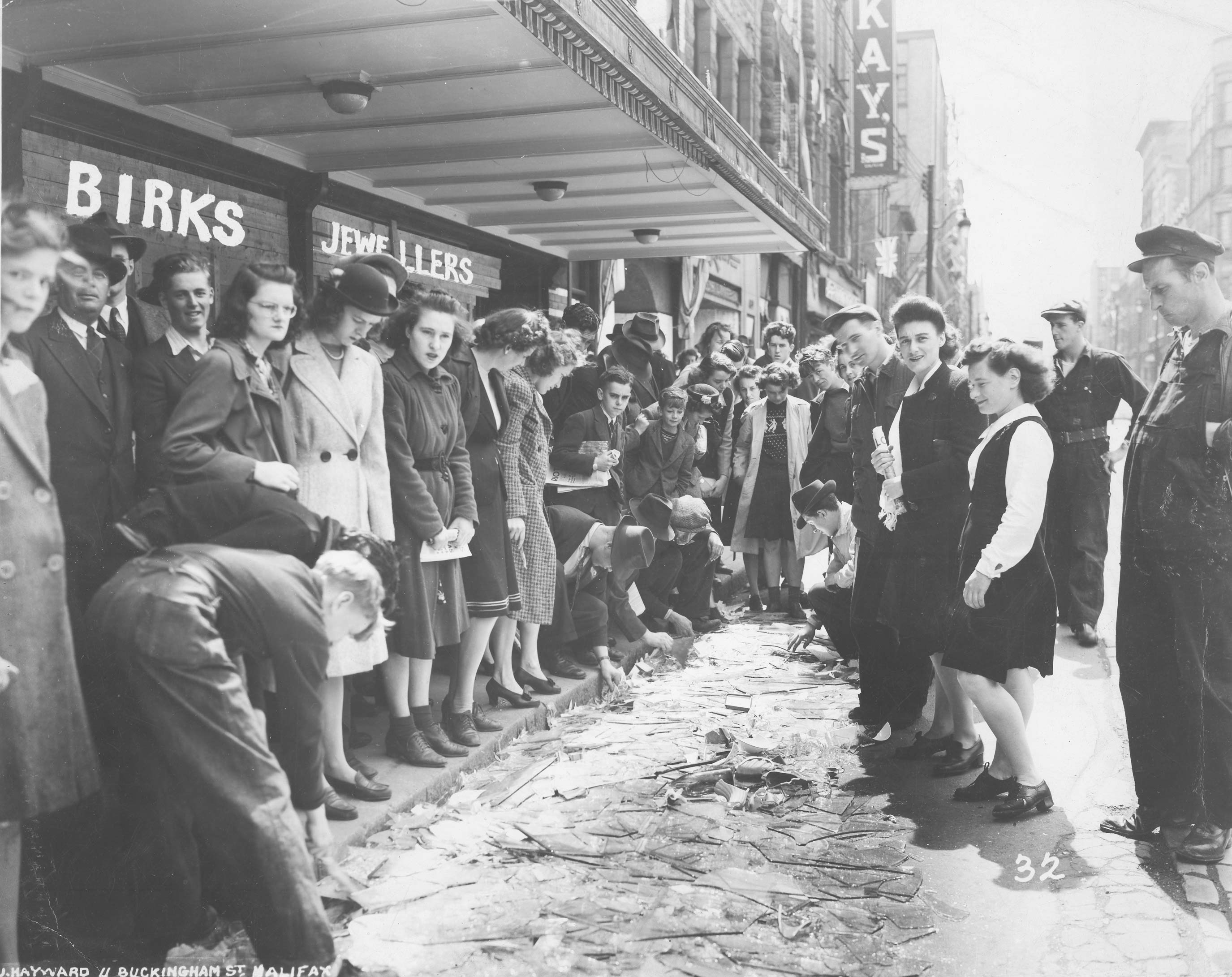 Crowd viewing broken glass on Barrington St., Halifax, after the Bedford Magazine Explosion, 18 July, 1945