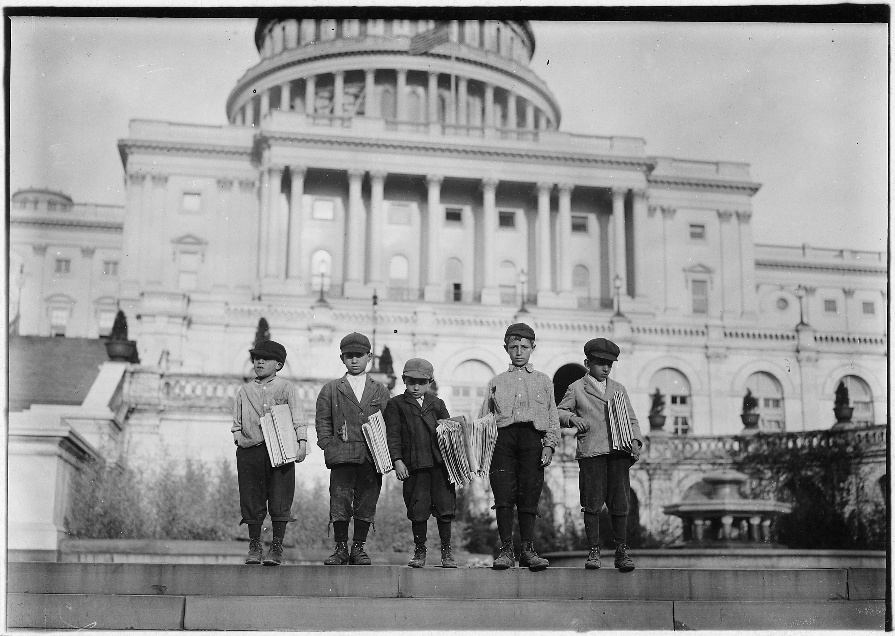 Group of newsies selling on capitol steps. Tony, 8 years old, Dan, 9 years old, Joseph, 10 years old, John, 11 years... - NARA - 523531