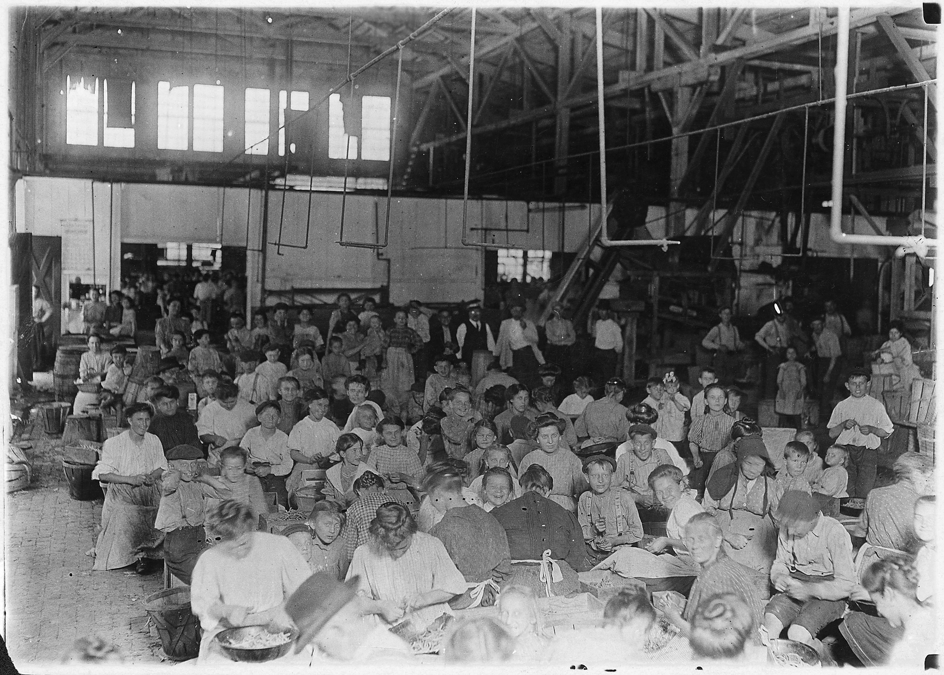 Group showing a few of the workers stringing beans in the J.S. Farrand Packing Co. Those too small to work are held... - NARA - 523214