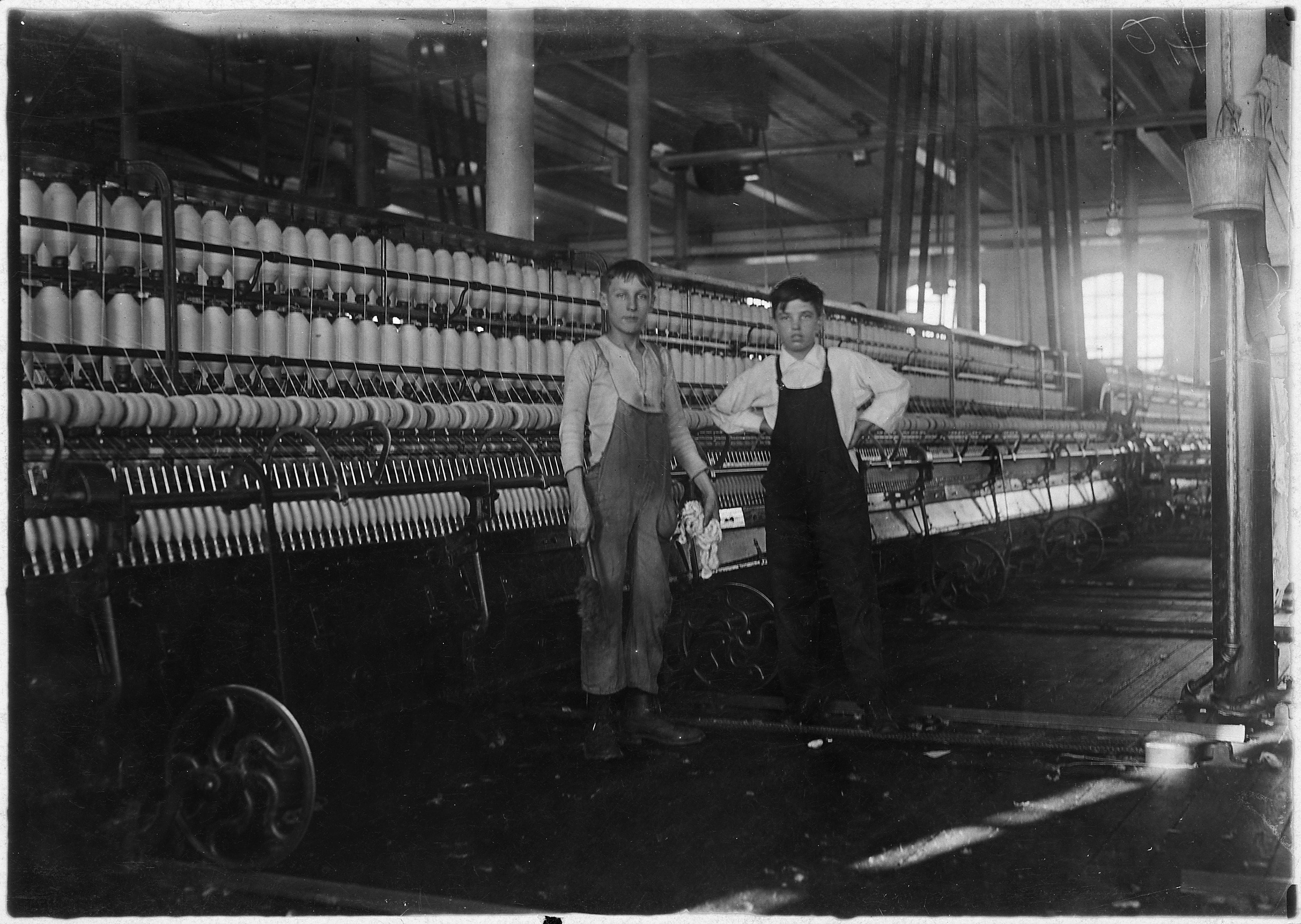Interior of Wamsutta Mill, New Bedford, Mass. Wilfred, youngest boy, appears thirteen years. He has been working a... - NARA - 523508