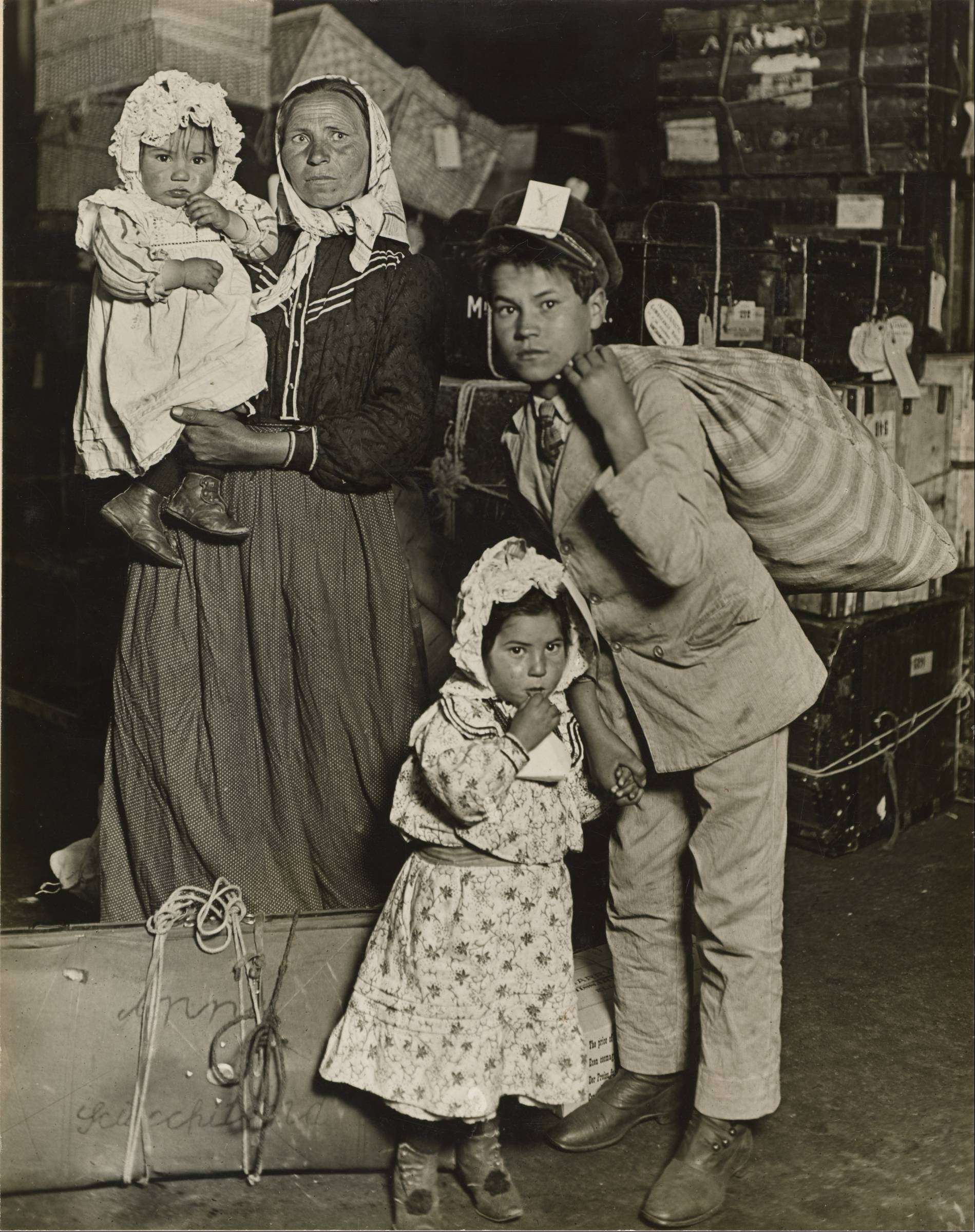 Lewis W. Hine - Immigrant Family in the Baggage Room of Ellis Island - Google Art Project