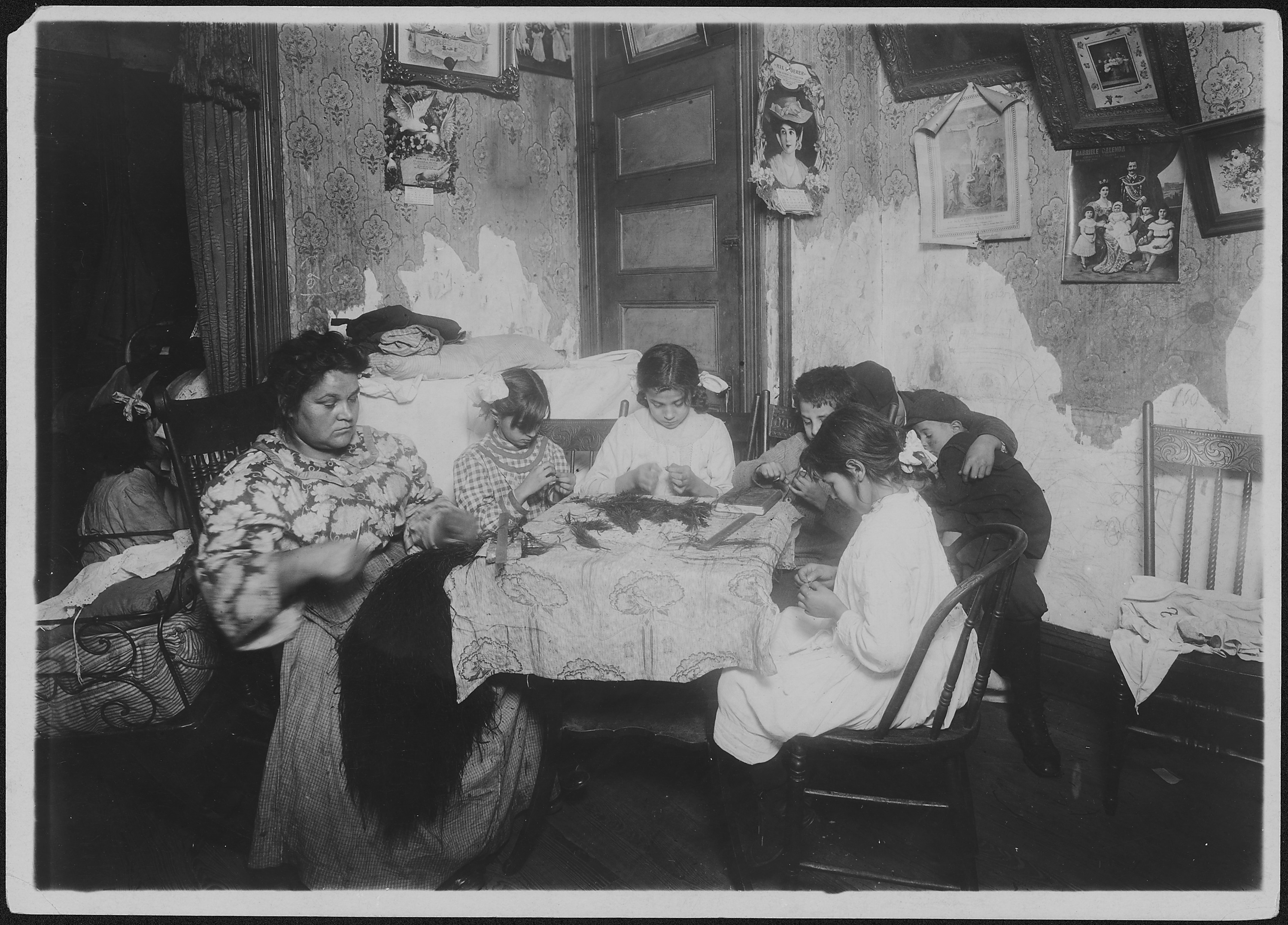 Mrs. Mauro, and family working on feathers, make $2.25 a week. In vacation two or three times as much. Victoria, 8... - NARA - 523502